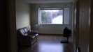 Living room, with entrances to the kitchen, first bedroom and balcony on the right (out of sight mostly).