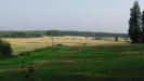 Large plains on the southern side of highway 6, with the highway going 100-200m behind my back. Salpa-line trenches stretch to the left and right of me, and over the hill on the right towards the taller trees.